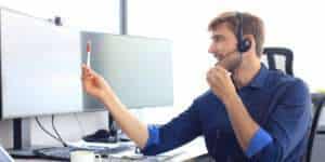 Happy young male customer support executive working in office.